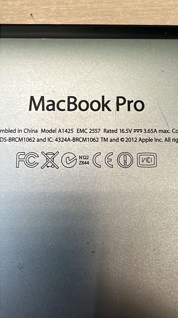 Grabado trasero indicando Modelo A1425 y EMC 2557 para confirmación de repuestos.