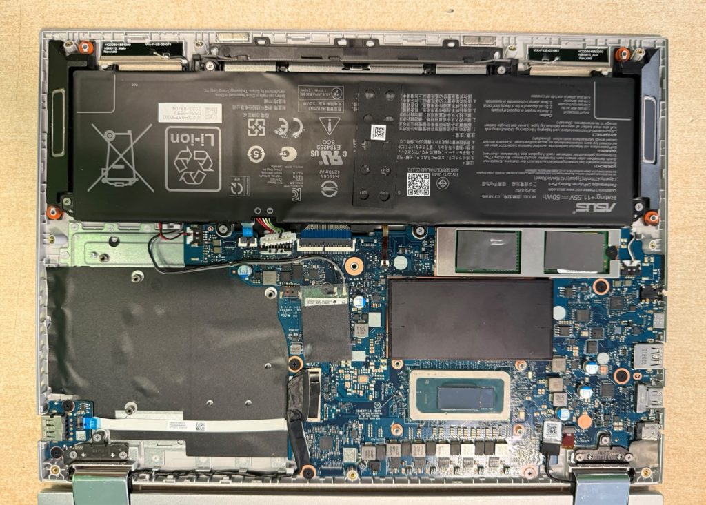 Esquina del chasis de aluminio abollada por caída junto a la bisagra del Asus TP3402Z.